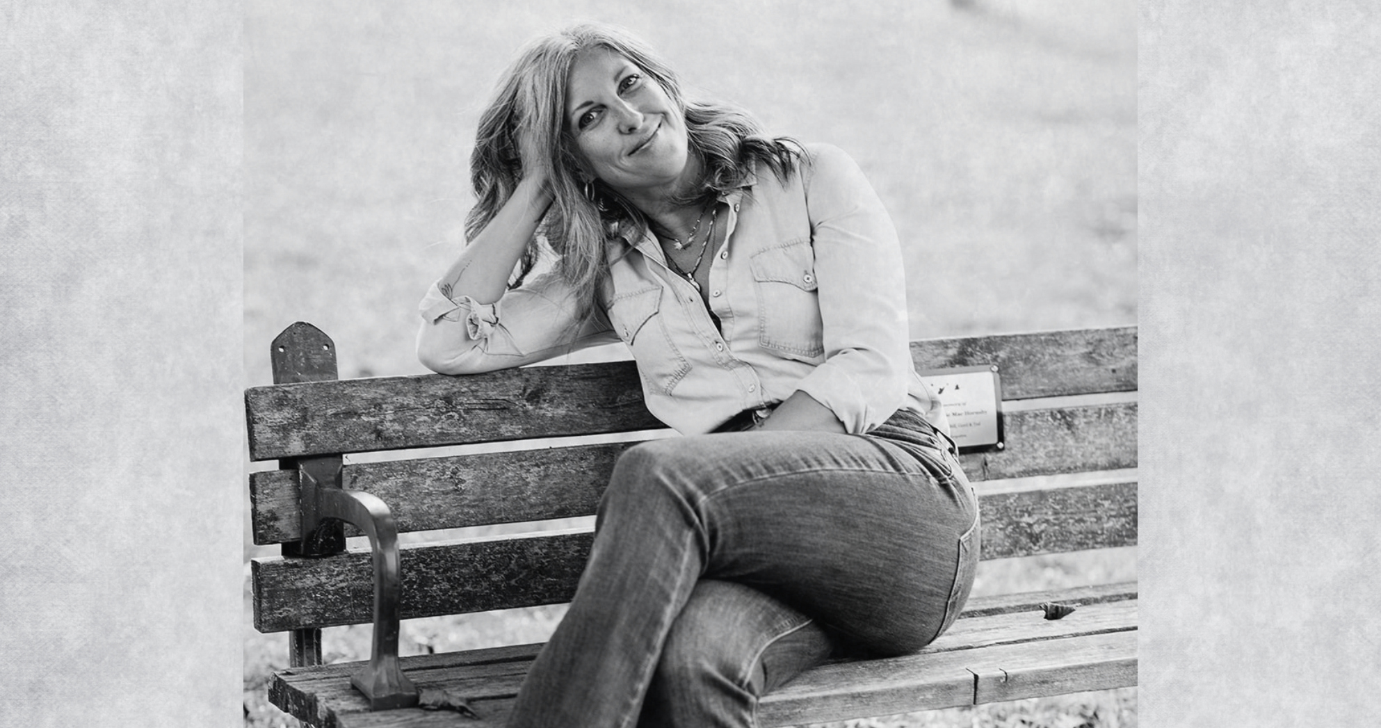 Dr. Melissa smiling on a park bench, representing positivity and healing.